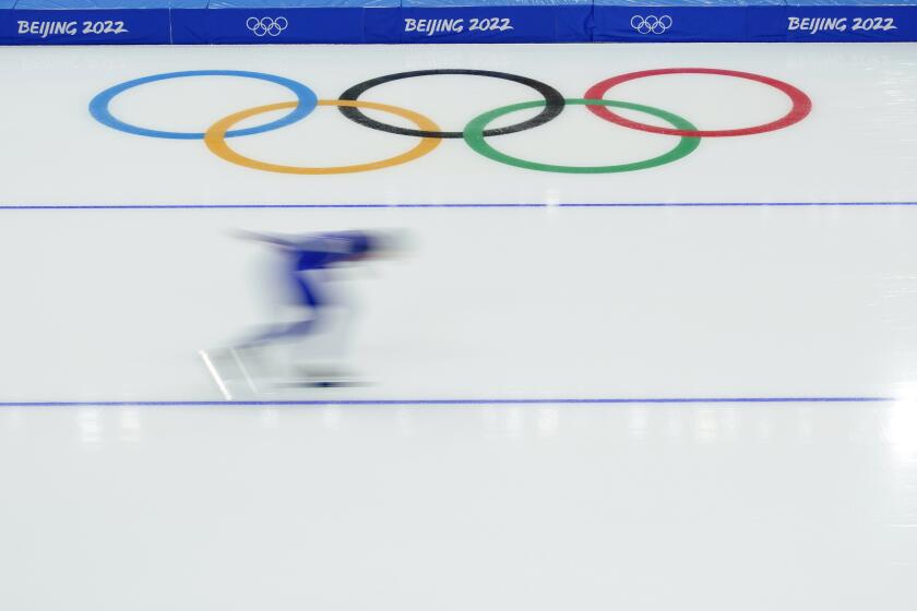 Athletes skate during a speedskating practice ahead of the 2022 Winter Olympics, Wednesday, Feb. 2, 2022, in Beijing. (AP Photo/Ashley Landis)