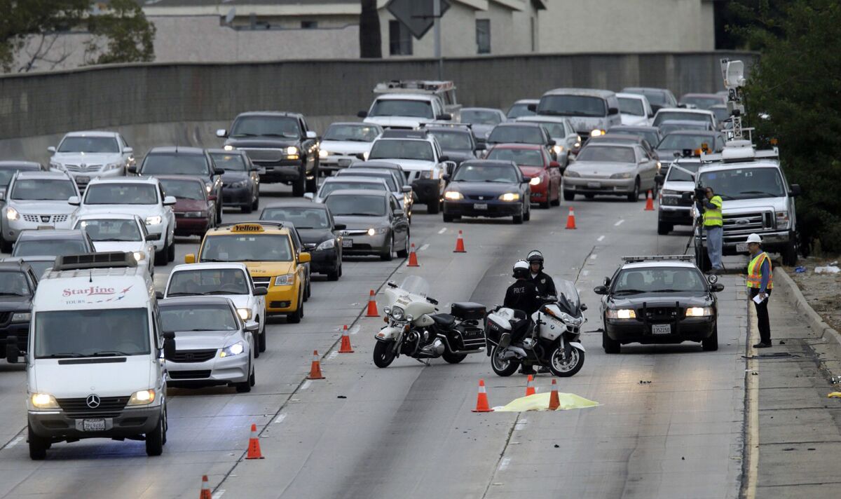 A woman believed to be 50 was struck and killed by a vehicle on the Hollywood (101) Freeway in the Silver Lake area Tuesday morning as she apparently tried to run across the roadway.