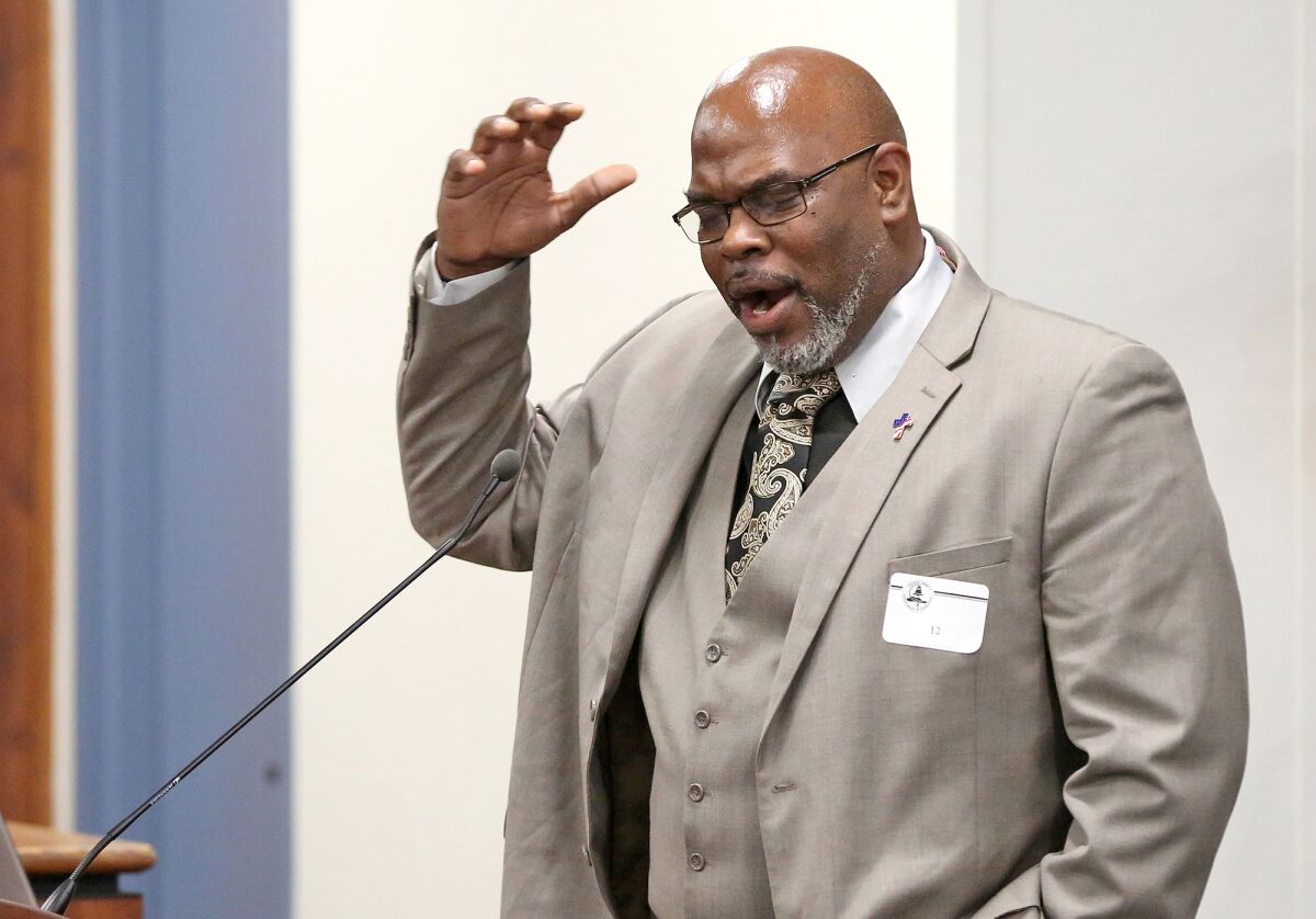 Pastor Brian Hawkins makes emotional comments Tuesday during a forum held by the Orange County Board of Education. 