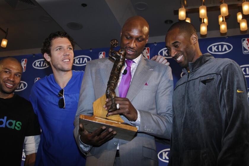 Lamar Odom, a forward for the Los Angeles Lakers, received the Sixth Man Award on April 19, 2011 at the Sheraton Gateway Hotel in Los Angeles with teammates Derek Fisher, Luke Walton and Kobe Bryant.