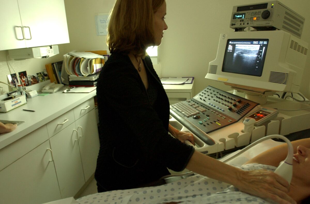 National Cancer Institute researchers have forecast an increase of up to 50% in U.S. breast cancer cases between 2011 and 2030. Here, a Los Angeles-area doctor demonstrates how she performs a breast ultrasound.