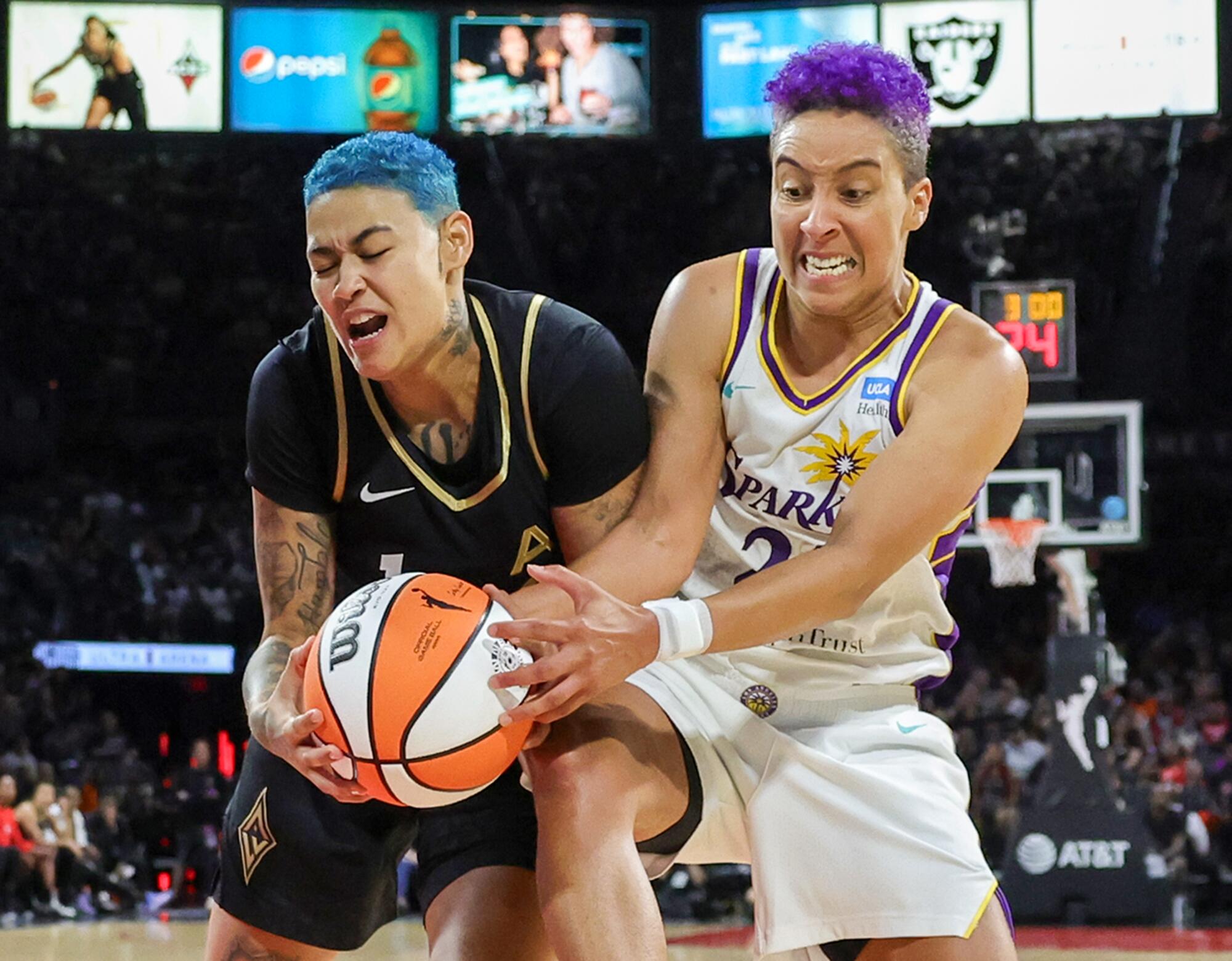 Sparks guard Lashia Clarendon, right, battles the Aces' Kierstan Bell for a rebound during a game Aug. 19 in Las Vegas.