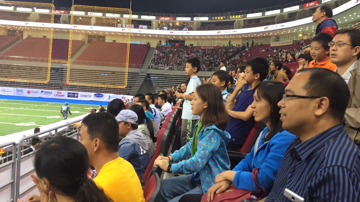 A crowd watches the Dalian Dragon Kings play the Shenzhen Naja in China's first professional football league.