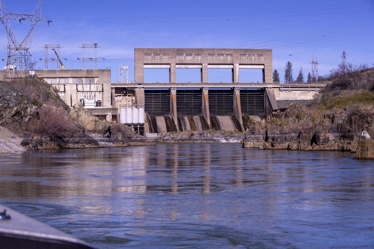 A dam looms over a river.