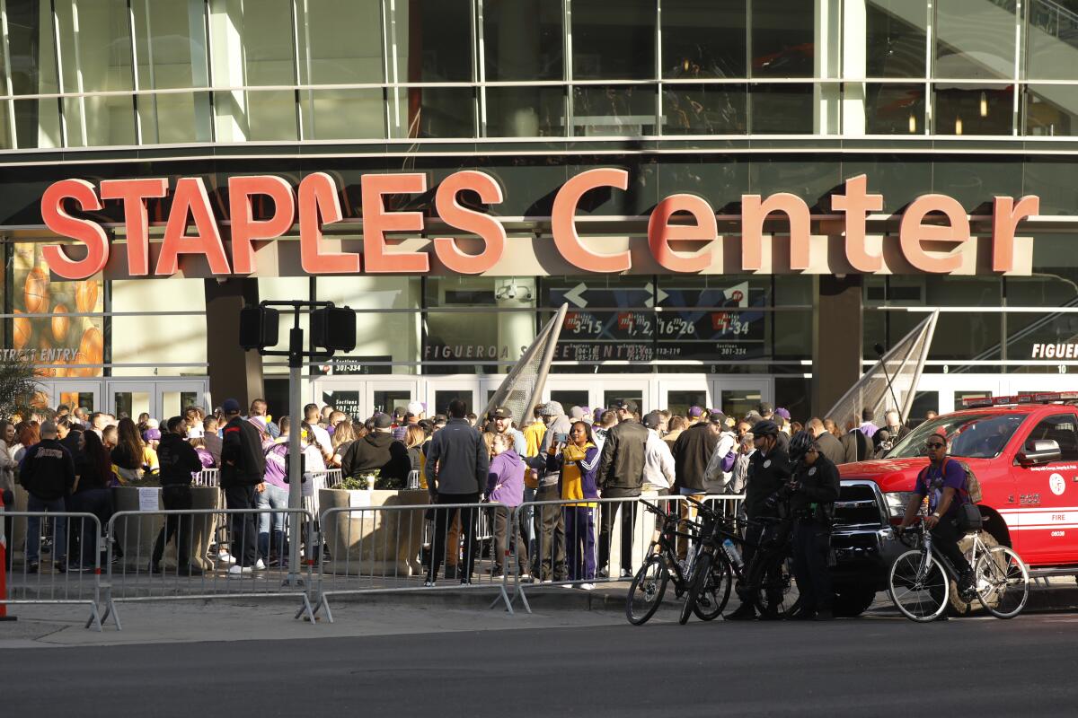 LOS ANGELES CA FEBRUARY 24, 2020 -- Fans gather outside Staples Center the the 'Celebration of Life' for Kobe and Gianna Bryant, honoring the late NBA legend and his 13-year-old daughter who died along with seven others in a helicopter crash in Calabasas last month. (Al Seib / Los Angeles Times)
