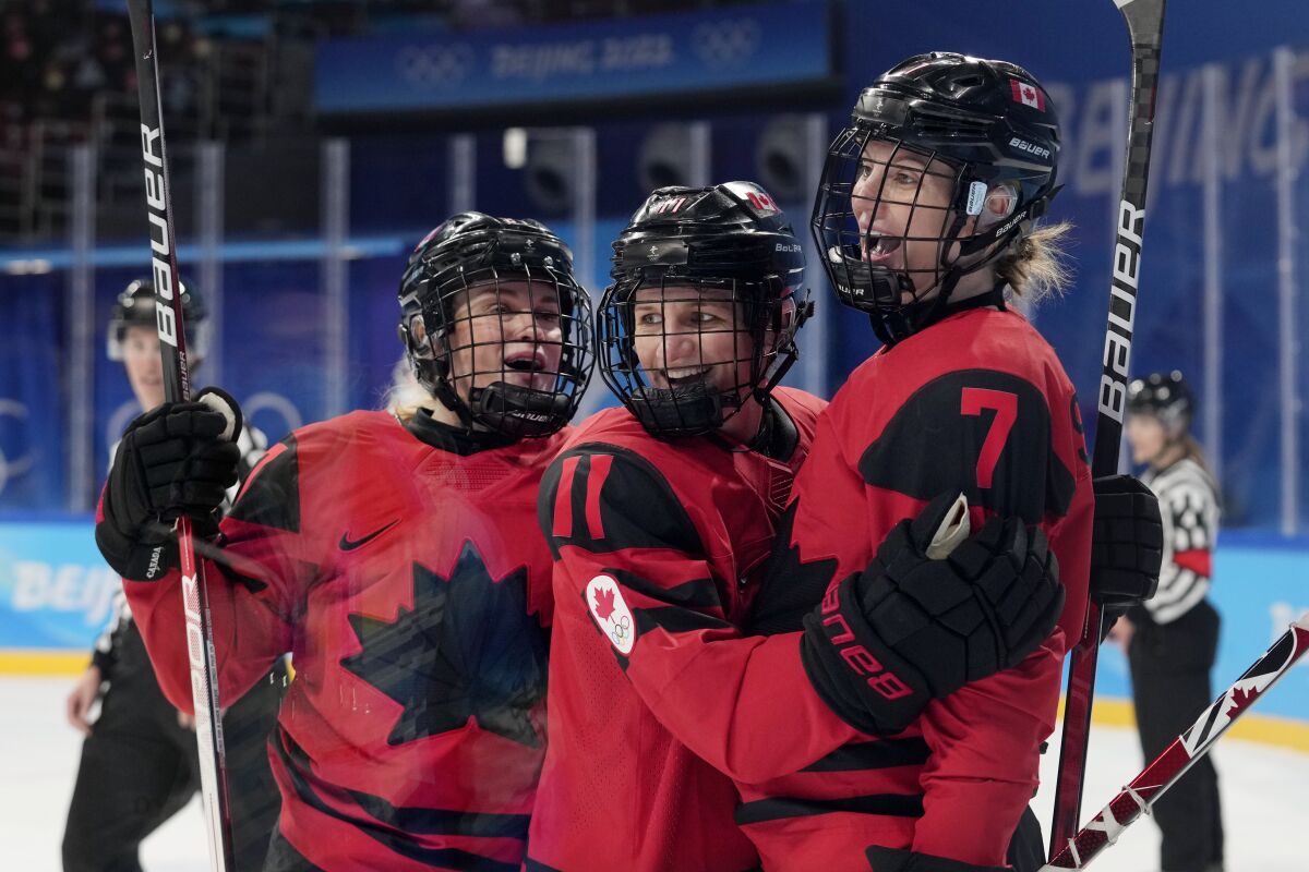 Canada's Laura Stacey is congratulated by Emma Maltais and Jill Saulnier after Stacey scored against Finland.