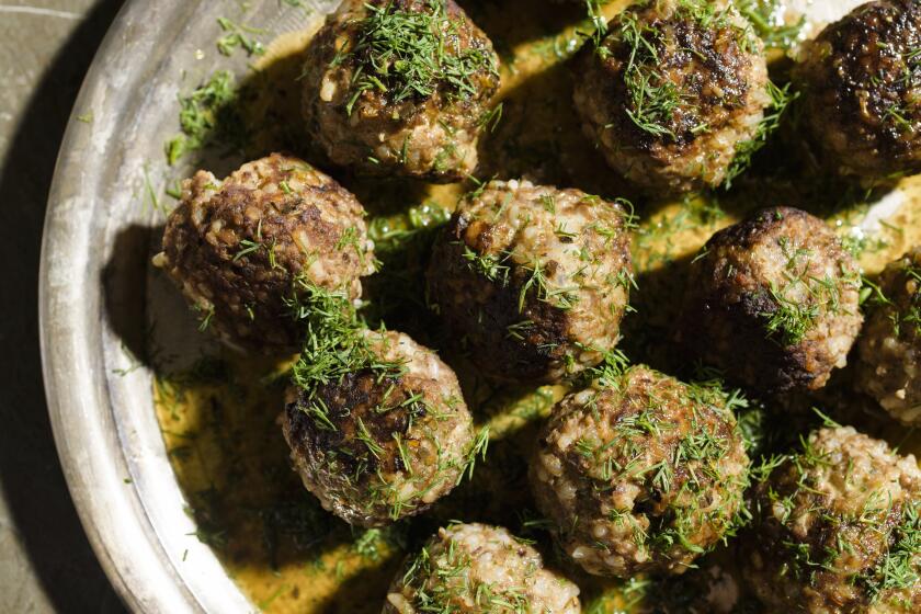 This image released by Milk Street shows a recipe for beef and rice meatballs with lemon-olive oil sauce. (Milk Street via AP)