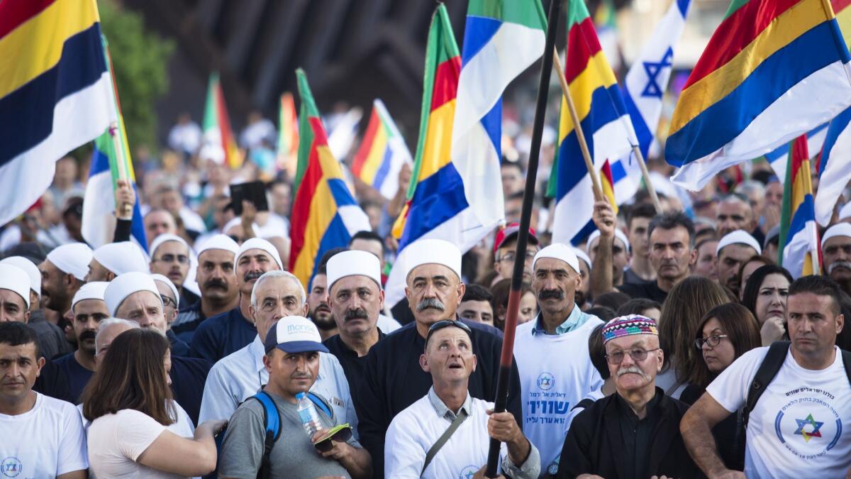Demonstrators take part in a protest Aug. 4 in Rabin Square, Tel Aviv.