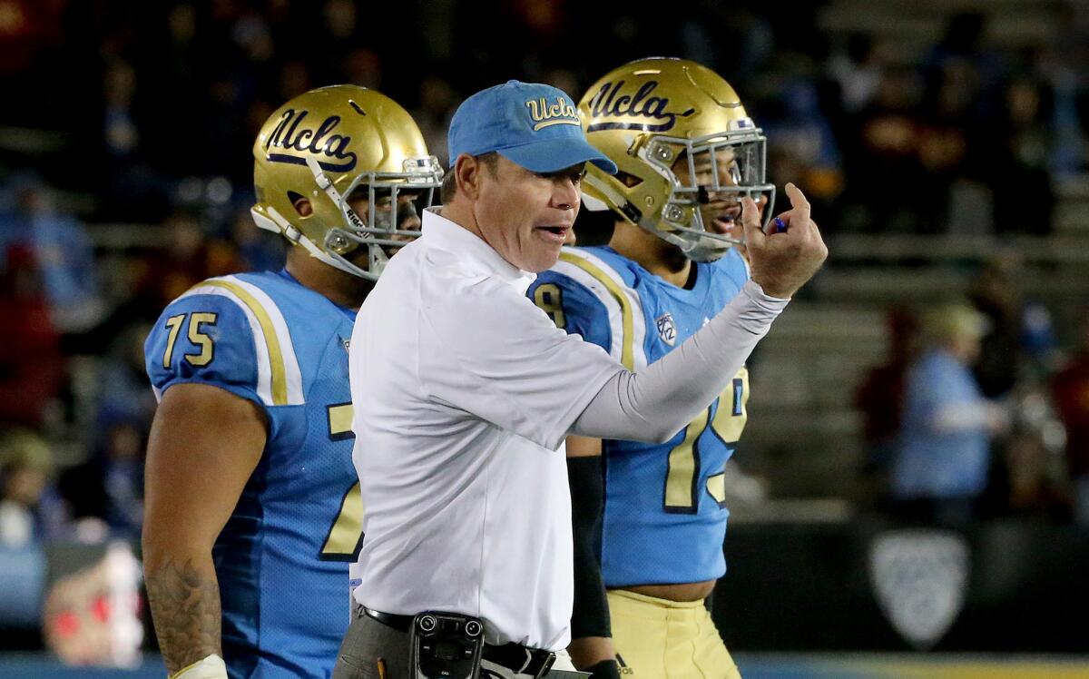 UCLA Coach Jim Mora directs his team against USC in the fourth quarter on Nov. 19.
