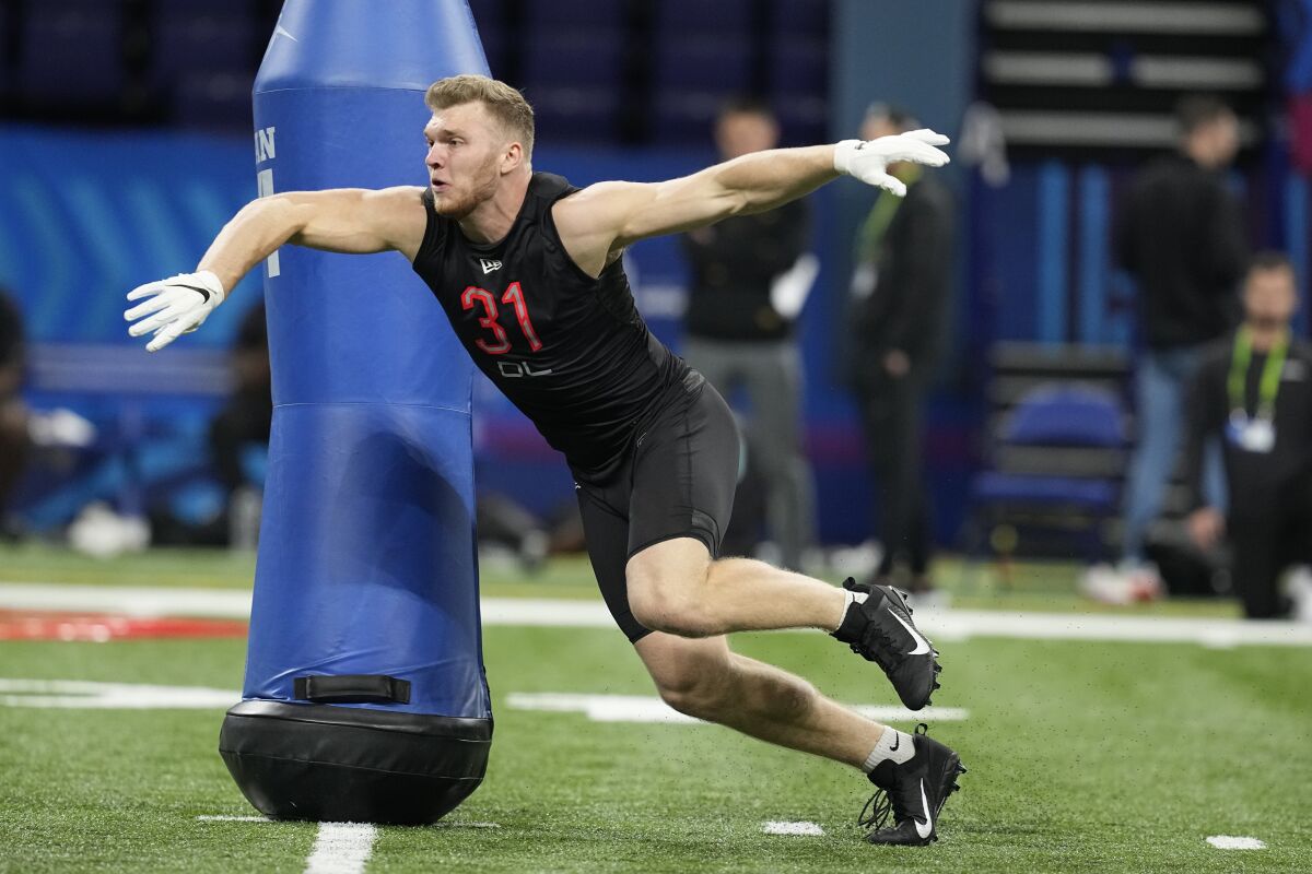 Michigan defensive lineman Aidan Hutchinson runs a drill at the NFL scouting combine in Indianapolis on March 5.