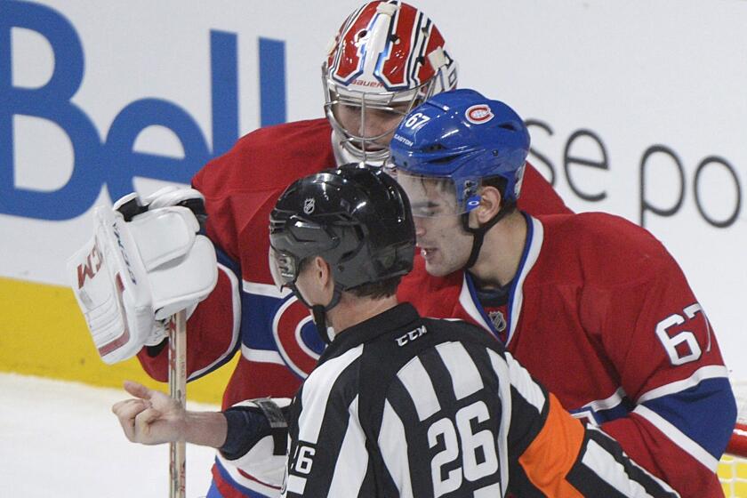 Montreal forward Max Pacioretty, with goaltender Carey Price looking on, shows his arm to a referee following a skirmish with Toronto's Mikhail Grabovski.