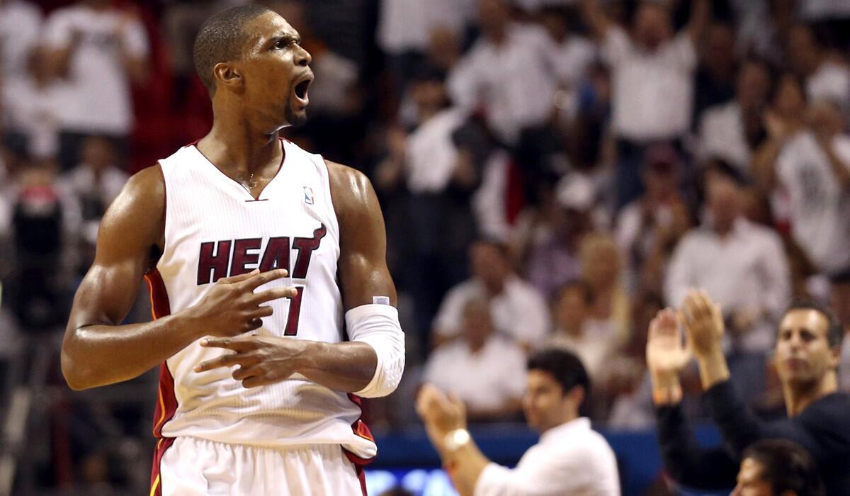 Heat power forward Chris Bosh reacts after scoring against the Pacers in the third quarter of Game 6 on Friday night in Miami.