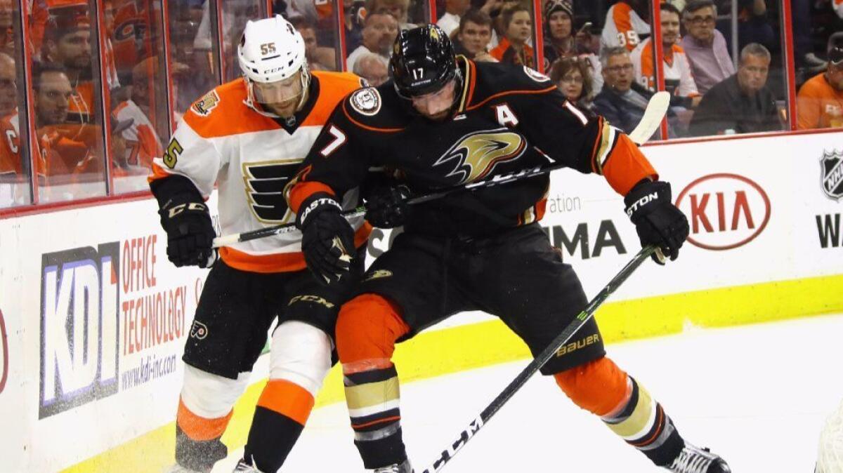 Ducks forward Ryan Kesler is held back by Flyers defenseman Nick Schultz during the first period of a game on Oct. 20.
