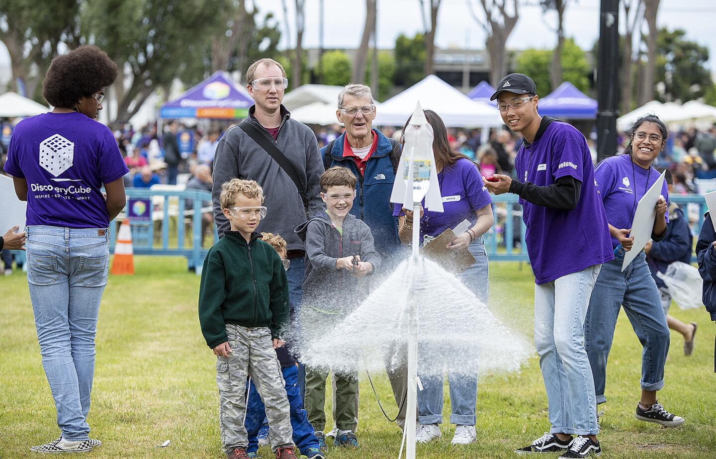 Andrew Jamison, 9, launches the bottle rocket he built as his brothers Quinn, 7, and Cranmore, 4, and father Eliot and grandfather Dick Williams watch during the annual Rocket Launch at Boeing Co. in Huntington Beach on Saturday. The event was co-presented by Discovery Cube Orange County.