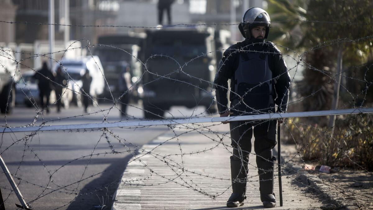 Egyptian riot police stand guard outside a police academy complex in Cairo where a new hearing in the trials of deposed president Mohamed Morsi opened.