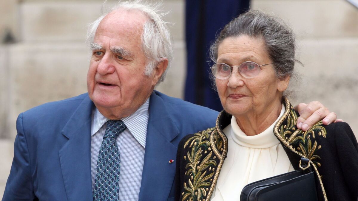 Simone Veil leaves the Institut de France with her husband, Antoine Veil, after her entry ceremony as member of the prestigious Academie Francaise, the guardian of the French language, on June 16, 2011.
