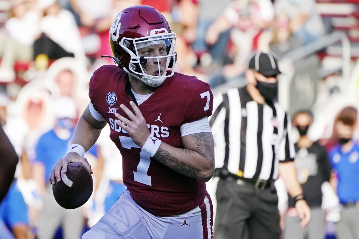 FIL - In this Nov. 7, 2020, file photo, Oklahoma quarterback Spencer Rattler (7) carries for a touchdown in the first half of an NCAA college football game against Kansas in Norman, Okla. (AP Photo/Sue Ogrocki, File)