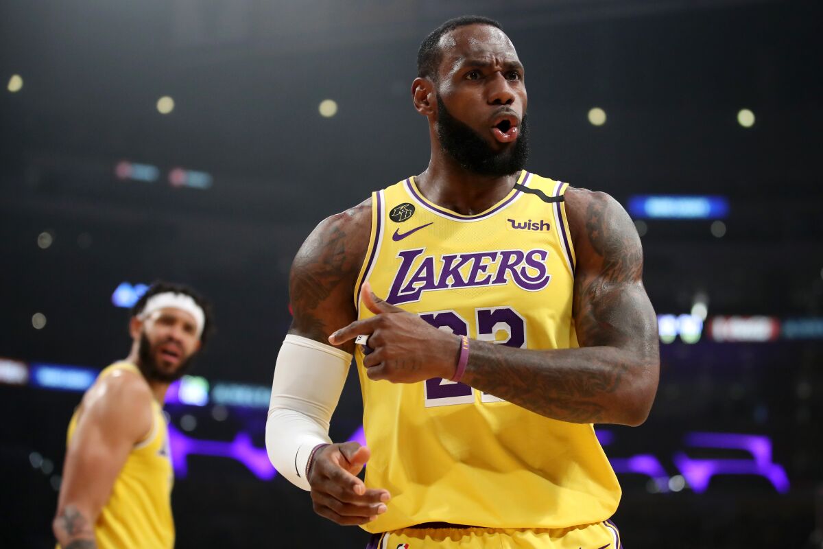 LeBron James and JaVale McGee react to a play during the first half of the Lakers' victory over the 76ers on March 3 at Staples Center.