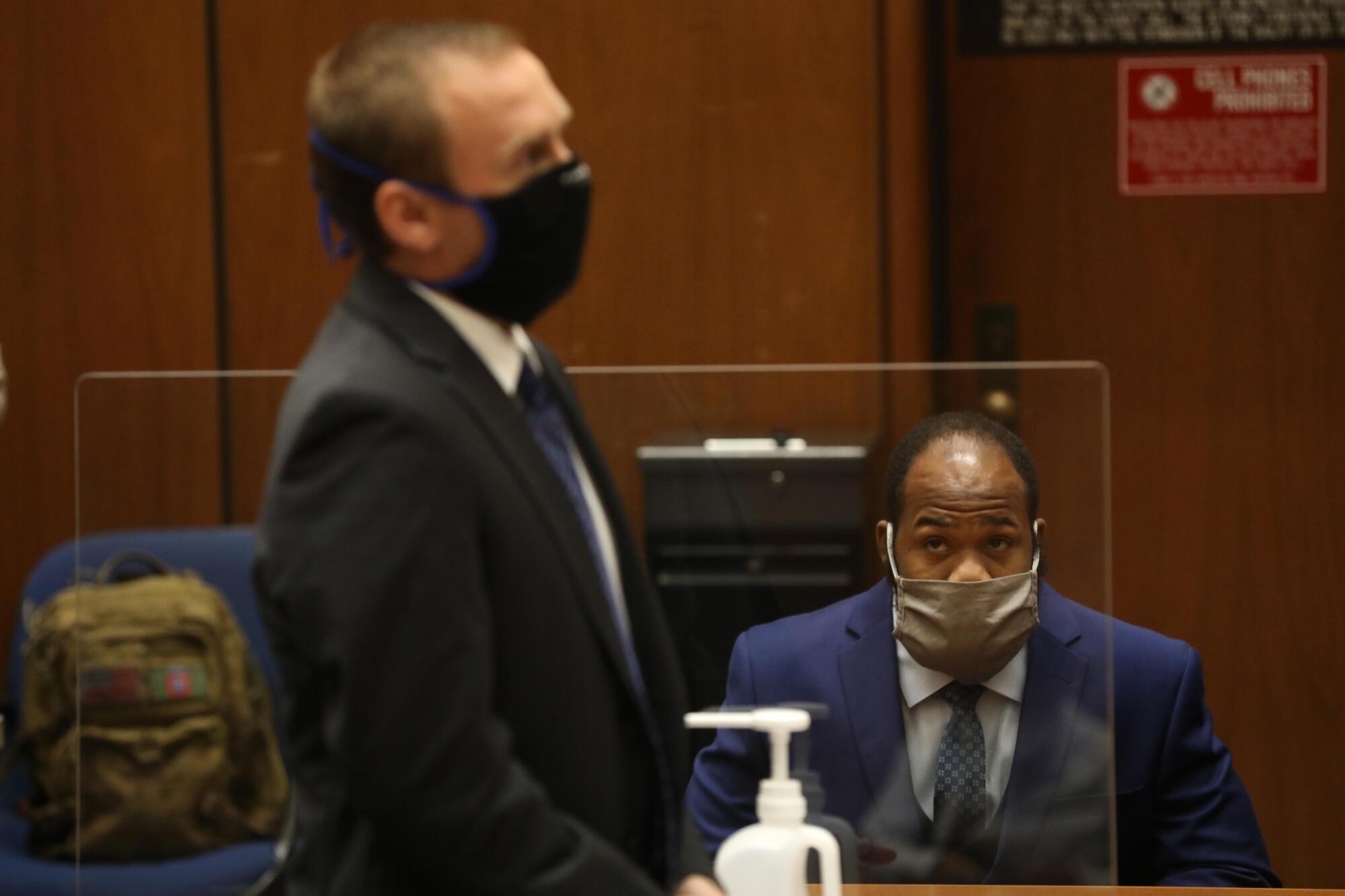 Attorney Mike Semanchik and Derrick Harris in a courtroom.