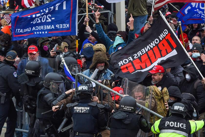 Trump supporters clash with police and security forces as they storm the US Capitol in Washington, DC on January 6, 2021. - Demonstrators breeched security and entered the Capitol as Congress debated the a 2020 presidential election Electoral Vote Certification. (Photo by ROBERTO SCHMIDT / AFP) (Photo by ROBERTO SCHMIDT/AFP via Getty Images)