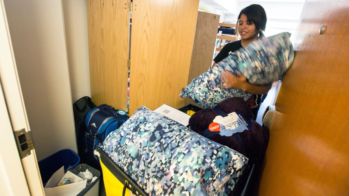 Ashley Sanchez unloads a cart with her belongings at her UCLA dorm room.