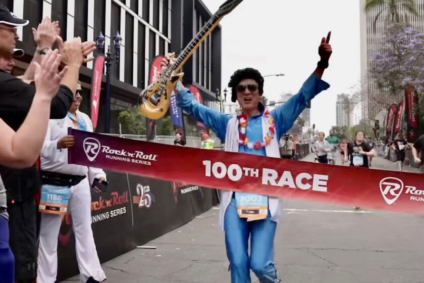 Henry Chan, 62, of Mira Mesa, who runs barefoot and dresses as Elvis, finished his 100th Rock 'n' Roll race here on June 4.
