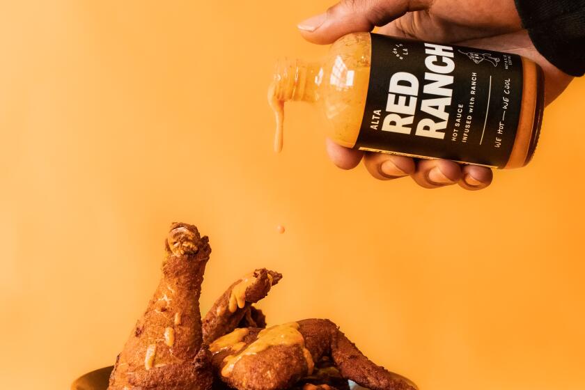 Alta Adams Red Ranch sauce being over fried chicken.