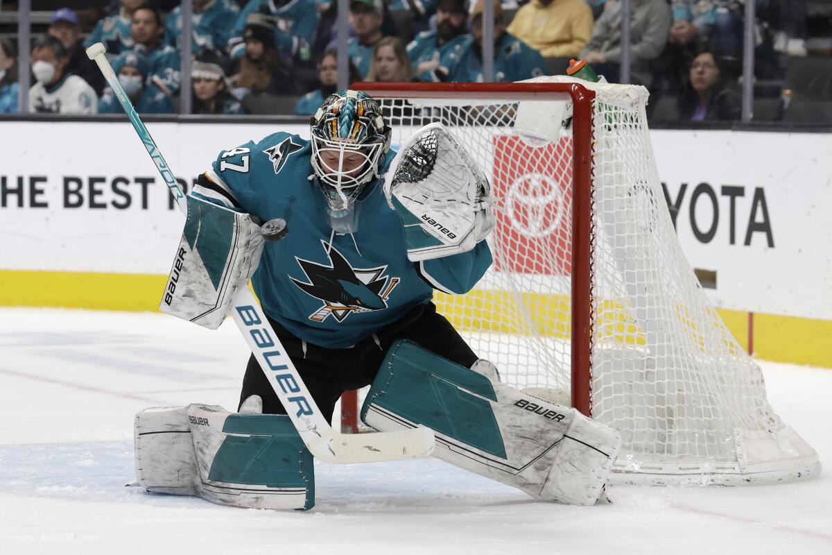 Sharks goalie James Reimer deflects a shot during the second period March 26, 2022. 