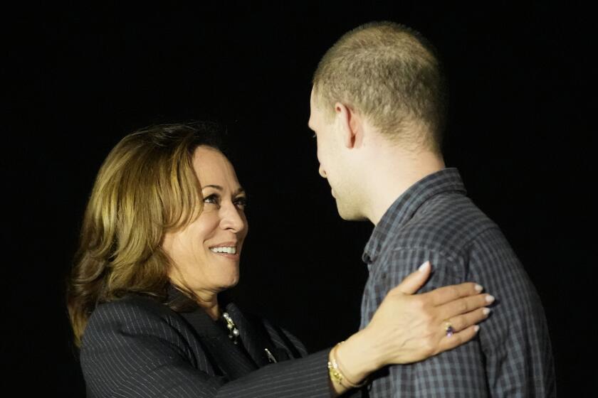 Vice President Kamala Harris, left, greet reporter Evan Gershkovich at Andrews Air Force Base, Md., following his release as part of a 24-person prisoner swap between Russia and the United States, Thursday, Aug. 1, 2024. (AP Photo/Alex Brandon)