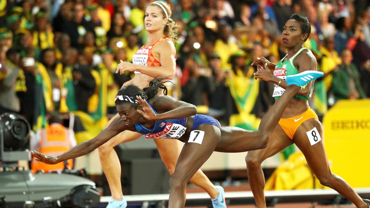 American Tori Bowie loses her balance and falls to the track after winning the 100-meter race Sunday at the world championships in London.