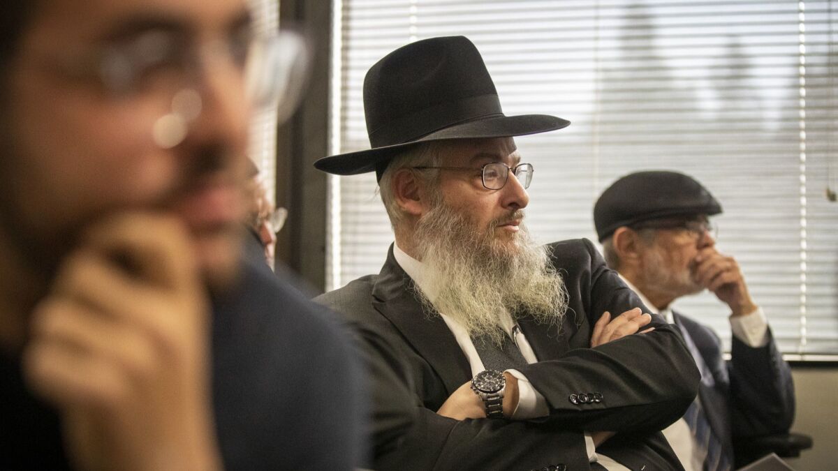 Rabbi Shmuel Manne, center, joins Hatzolah supporters at an ambulance license hearing in Santa Fe Springs. Manne is chairman of the Jewish volunteer emergency medical service.