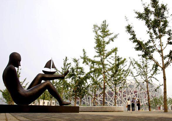 A sculpture greets visitors outside Beijing's 100,000-seat Olympic stadium, known as the "Bird's Nest." The architectural additions to the capital, which also include a $3-billion airport terminal, helped drive the cost of the Beijing Games to a record-smashing $43 billion.