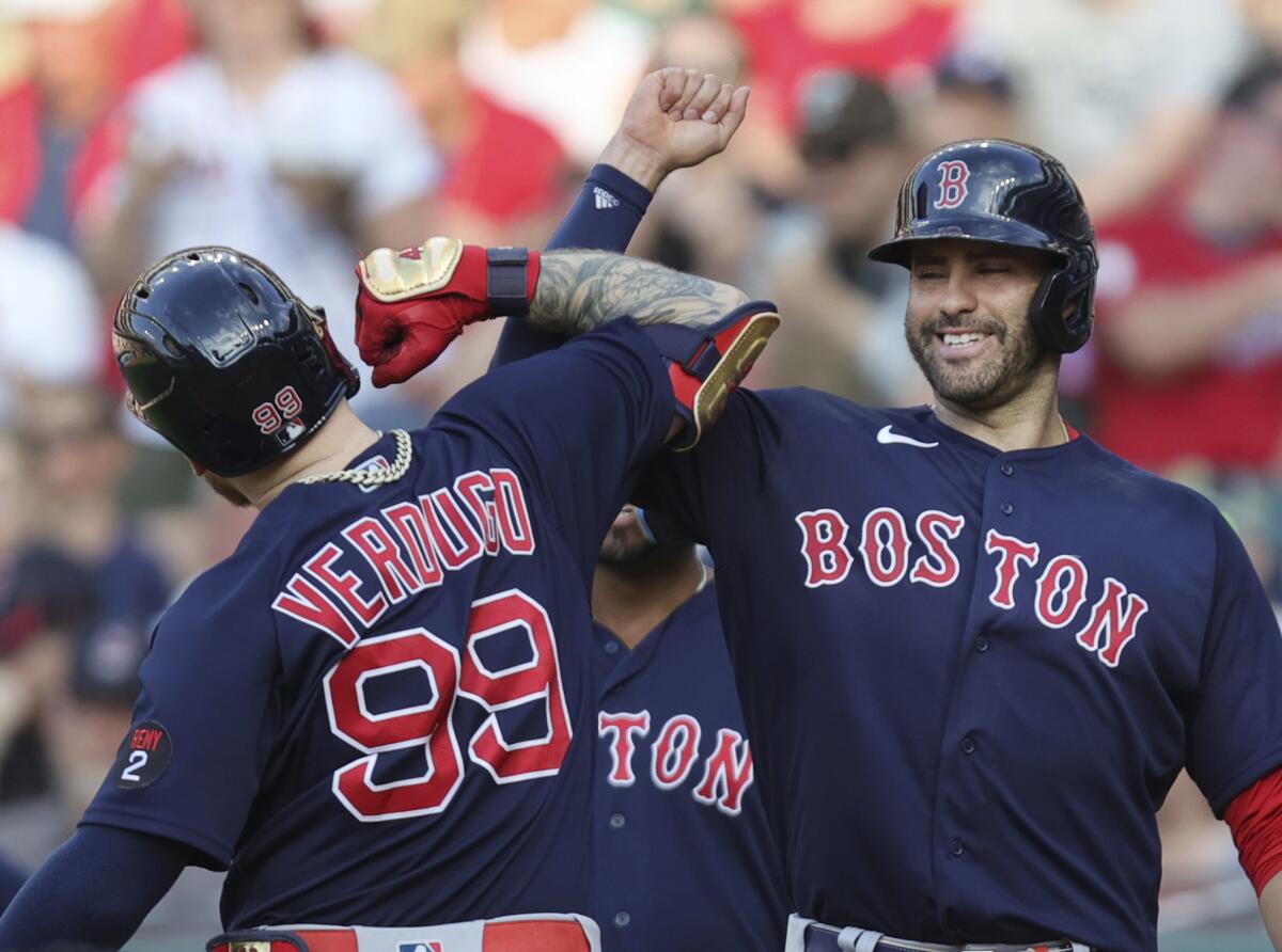 Boston Red Sox's J.D. Martinez, right, celebrates a three-run home run by Alex Verdugo (99) against the Cleveland Guardians during the sixth inning of a baseball game Saturday, June 25, 2022, in Cleveland. (John Kuntz/Cleveland.com via AP)