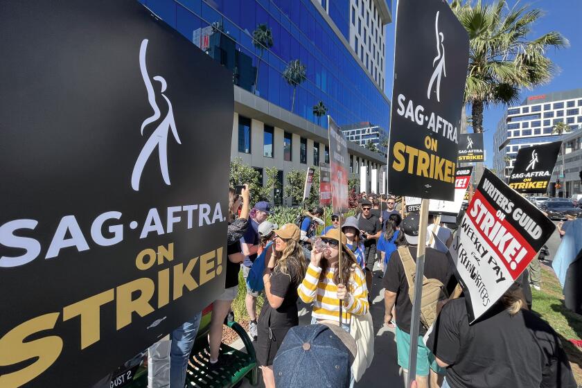 LOS ANGELES, CA - JULY 14: SAG-AFTRA members take to the picket line outside Netflix in Los Angeles, CA on Friday, July 14, 2023. Actors join striking writers who have been on the picket lines since the beginning of May. (Myung J. Chun / Los Angeles Times)