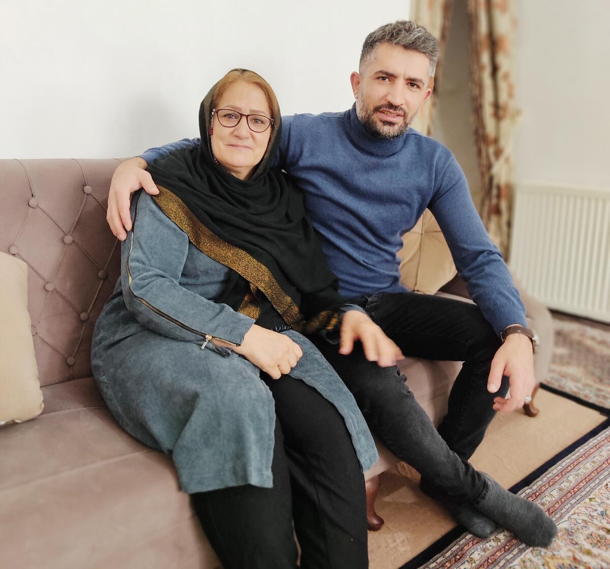 Woman and her adult son sitting on a sofa