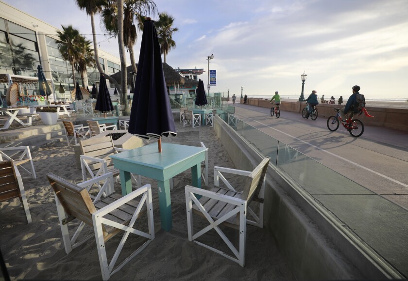 Tables sit empty at the Beach House Grill in Mission Beach.
