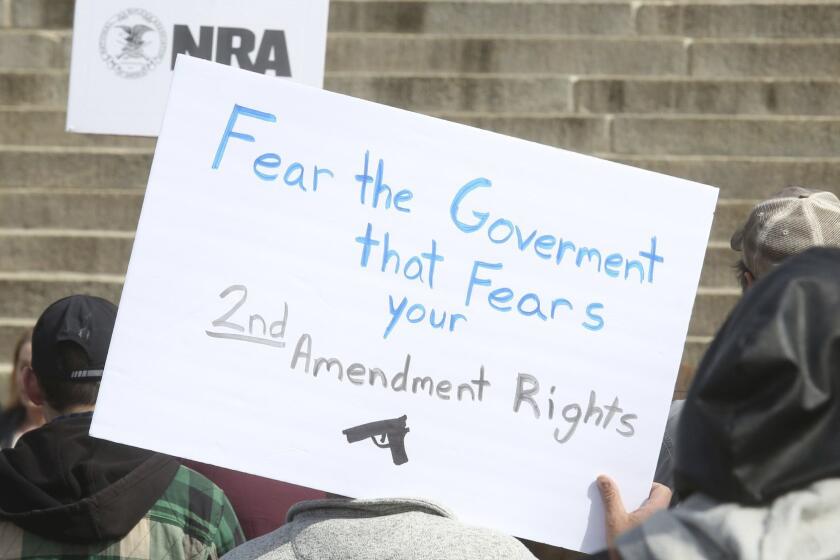People gathered Friday, April 20, 2018, for a 2nd Amendment rally on the steps of the Kansas Statehouse. (Thad Allton /The Topeka Capital-Journal via AP)