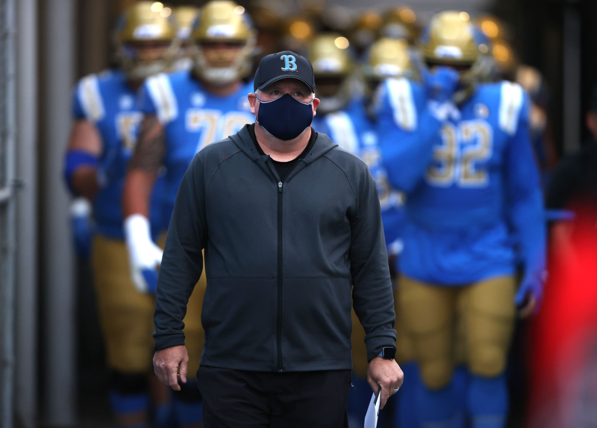 Coach Chip Kelly and the UCLA Bruins enter the stadium for a game.