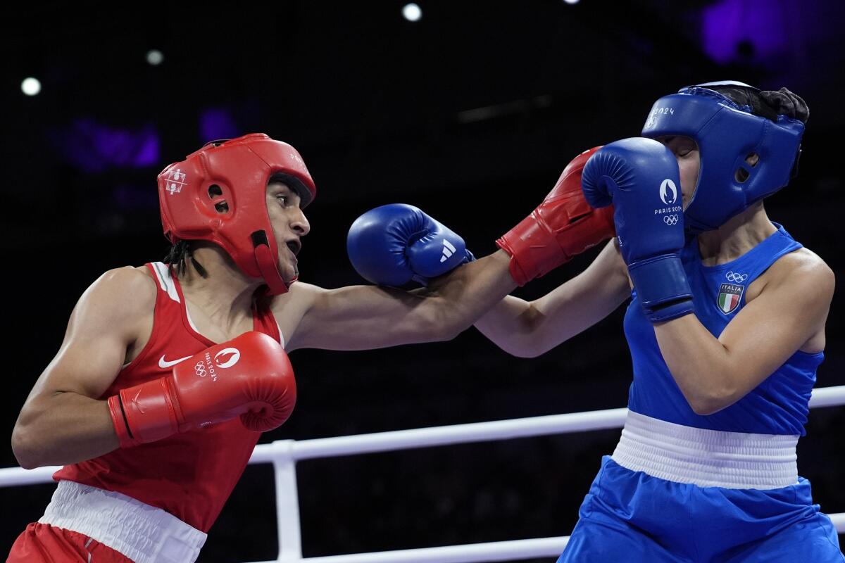 Algeria's Imane Khelif, left, fights Italy's Angela Carini in their women's 66 kilogram preliminary match Thursday.