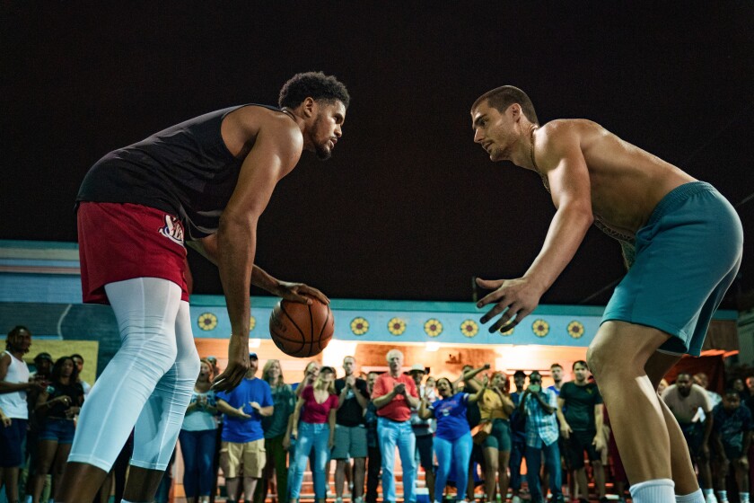 Two men play basketball while viewers watch the film "Hurry."