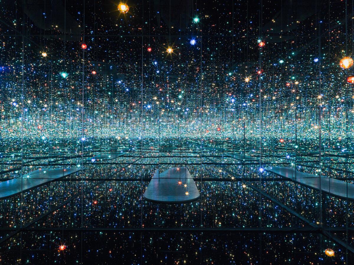 A mirrored art installation featuring colored dots.