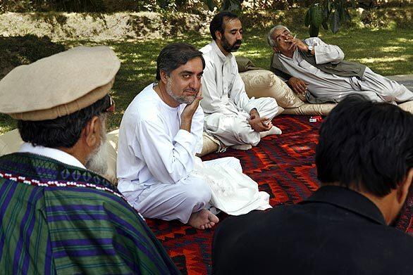 Abdullah meets with supporters in his private garden outside Kabul.