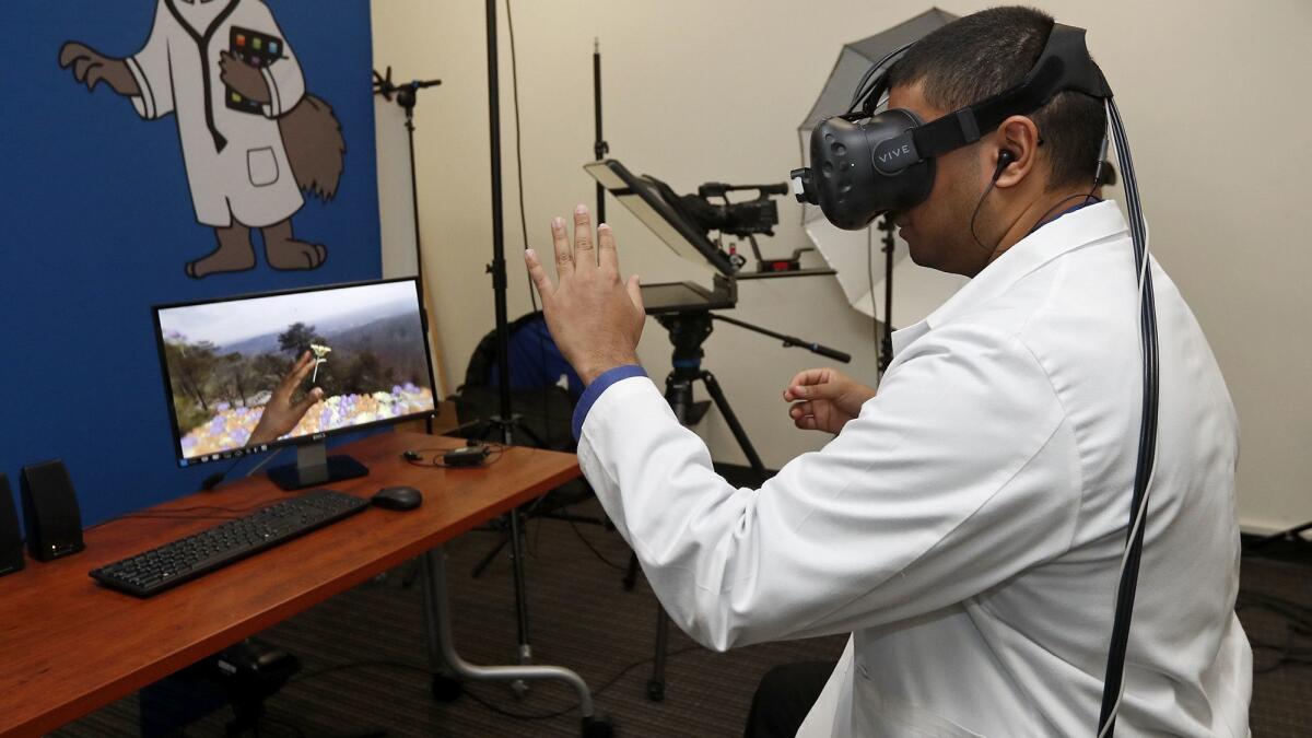 Mark Rupasinghe, a third-year UC Irvine medical student, demonstrates a virtual patient experience as part of the school’s virtual reality program that helps caregivers better understand the plight of their patients.