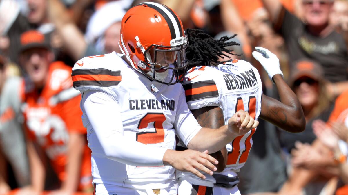 Browns quarterback Johnny Manziel celebrates with wide receiver Travis Benjamin after the two connected for a 60-yard touchdown against the Titans in the first half Sunday.