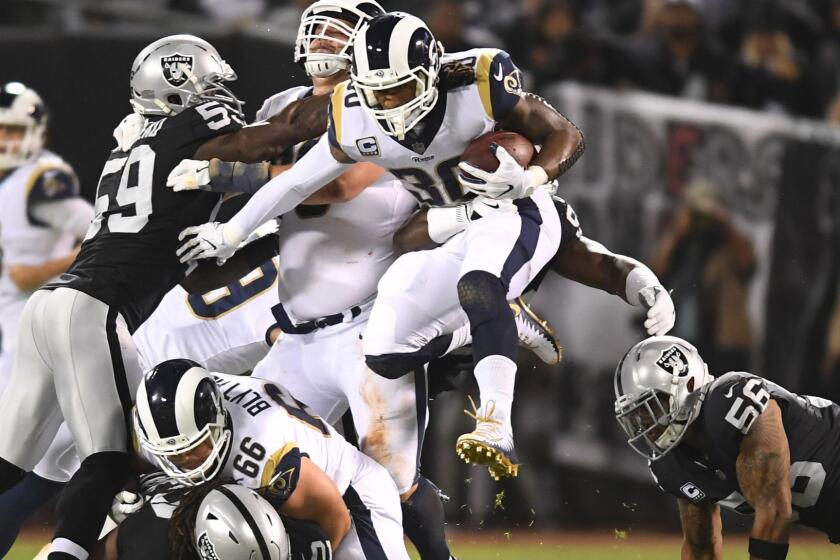 OAKLAND, CALIFORNIA SEPTEMBER 10, 2018-Rams running back Todd Gurley leaps over the defense to pick up yards against Oakland inthe 2nd quarter at the Oakland Coliseum Monday night. (Wally Skalij/Los Angeles TImes)