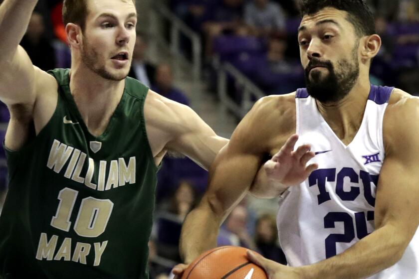 TCU guard Alex Robinson (25) drives against William & Mary guard Connor Burchfield (10) during the first half of an NCAA college basketball game in Fort Worth, Texas, Friday, Dec. 22, 2017. (AP Photo/LM Otero)