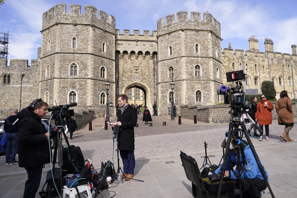 Members of the media wait outside Windsor Castle.