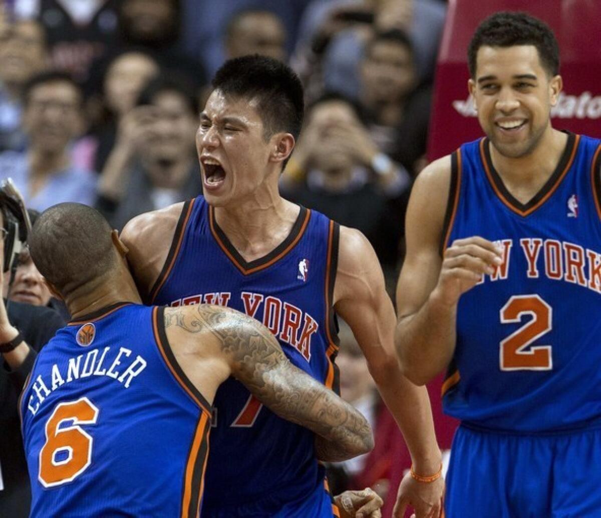 Jeremy Lin, center, celebrates with teammates Tyson Chandler, left, and Landry Fields after hitting a game-winning three-pointer with less than half a second left to lift the Knicks to a 90-87 victory over the Toronto Raptors in February.