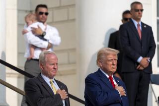 Bob Quackenbush, left, deputy chief of staff for Arlington National Cemetery, and Republican presidential nominee former President Donald Trump watch the changing of the guard at the Tomb of the Unknown Solider at Arlington National Cemetery, Monday, Aug. 26, 2024, in Arlington, Va. (AP Photo/Alex Brandon)