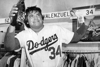 Dodger pitcher Fernando Valenzuela raises a magnum of champagne as the Dodgers toast their NL West victory against the Houston Astros in a clubhouse celebration on Oct. 12, 1981.